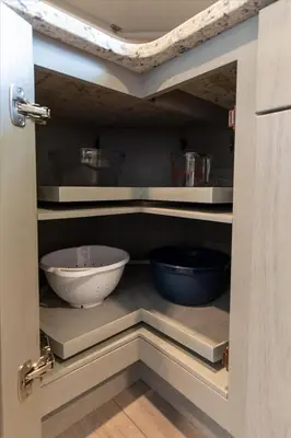 a kitchen with two mixing bowls in a cabinet at Joyful 5-Bedroom Home in Harrisburg