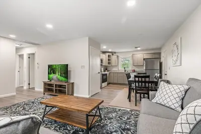 a living room with a couch and a table at Joyful 5-Bedroom Home in Harrisburg
