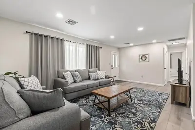 a living room with a couch and a table at Joyful 5-Bedroom Home in Harrisburg