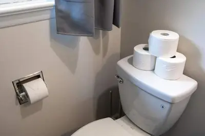 a bathroom with a toilet with three rolls of toilet paper at Joyful 5-Bedroom Home in Harrisburg
