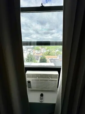 a view of a window with a air conditioner at Sunny Jersey City 1BR, 25 min to NYC, 15min to EWR, King Bed, Hammock & Park Views in Jersey City