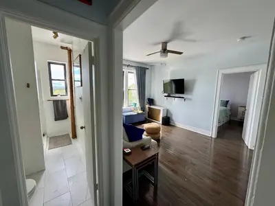 a living room with a couch and a table at Sunny Jersey City 1BR, 25 min to NYC, 15min to EWR, King Bed, Hammock & Park Views in Jersey City