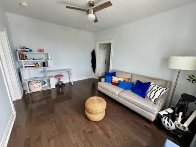 a living room with a couch and a table at Sunny Jersey City 1BR, 25 min to NYC, 15min to EWR, King Bed, Hammock & Park Views in Jersey City