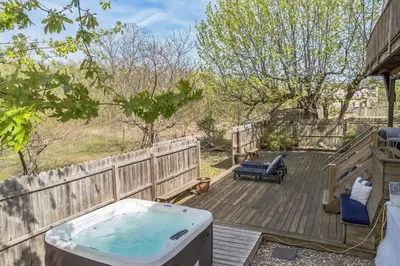 a hot tub sitting on a wooden deck at Beach front oasis - Hot tub - Sleeps 7 in Keansburg