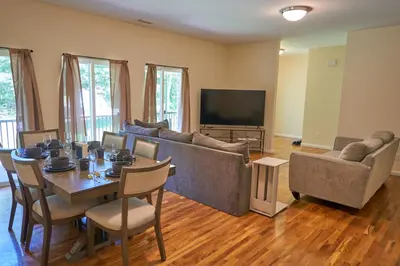 a living room with a table and a television at Cozy Huguenot Hideaway in Huguenot