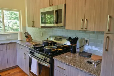 a kitchen with a stove with pots and pans on it at Cozy Huguenot Hideaway in Huguenot