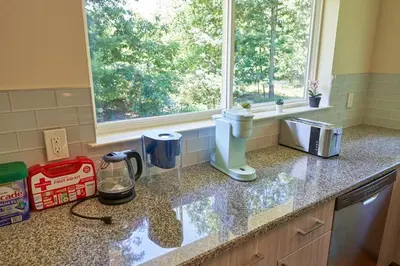 a kitchen counter with a coffee maker and a window at Cozy Huguenot Hideaway in Huguenot