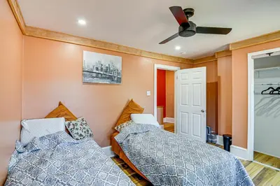 a bedroom with two beds and a ceiling fan at Walkable Location, Near PGA Champ! Updated Home