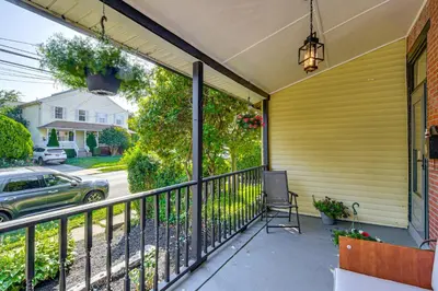 a balcony with a railing and a car on a street at Walkable Location, Near PGA Champ! Updated Home