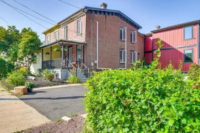 a brick house with a red and yellow house at Walkable Location, Near PGA Champ! Updated Home