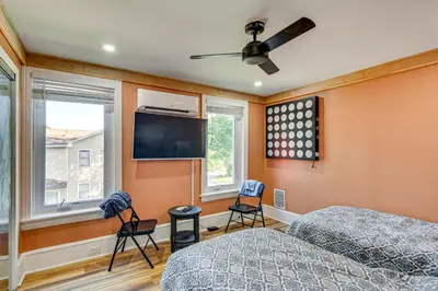 a bedroom with two beds and a flat screen tv at Walkable Location, Near PGA Champ! Updated Home