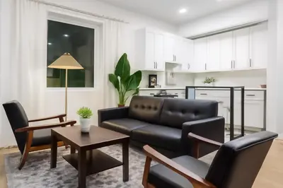a living room with a couch and a table at Modern 2BR Cozy City Retreat Free Parking in Philadelphia