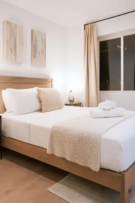 a bedroom with a large white bed and a window at Modern 2BR Cozy City Retreat Free Parking in Philadelphia