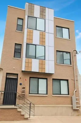a tall brick building with white and brown windows at Modern 2BR Cozy City Retreat Free Parking in Philadelphia