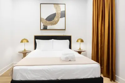 a bedroom with a bed with two towels on it at Modern 2BR Cozy City Retreat Free Parking in Philadelphia