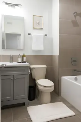 a bathroom with a toilet and a sink and a tub at Modern 2BR Cozy City Retreat Free Parking in Philadelphia