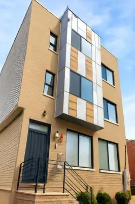 an apartment building with yellow and white at Modern 2BR Cozy City Retreat Free Parking in Philadelphia