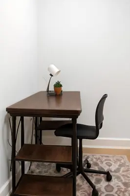 a desk with a lamp and a chair at Modern 2BR Cozy City Retreat Free Parking in Philadelphia