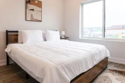 a bedroom with a large white bed with a window at 2Bed,Bath&WDWIFICentralToaster in Philadelphia