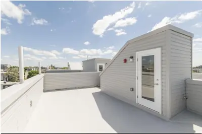 a white building on a roof with a patio at 2Bed,Bath&WDWIFICentralToaster in Philadelphia