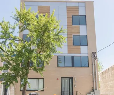 an apartment building with a tree in front of it at 2Bed,Bath&WDWIFICentralToaster in Philadelphia