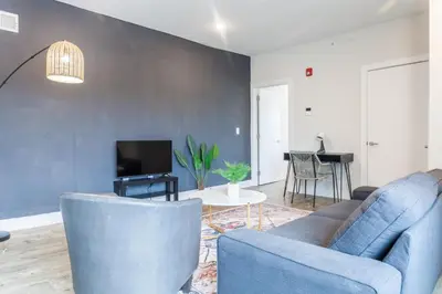 a living room with a blue couch and a tv at 2Bed,Bath&WDWIFICentralToaster in Philadelphia