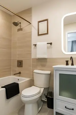 a bathroom with a white toilet and a sink at Modern 2BR&2BAQueen BedWork DeskWiFiWD in Philadelphia