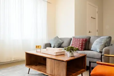 a living room with a couch and a coffee table at Modern 2BR&2BAQueen BedWork DeskWiFiWD in Philadelphia