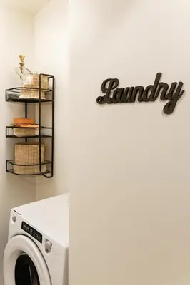 a laundry sign on a wall next to a washing machine at Modern 2BR&2BAQueen BedWork DeskWiFiWD in Philadelphia