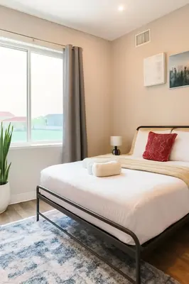 a bedroom with a bed with a large window at Modern 2BR&2BAQueen BedWork DeskWiFiWD in Philadelphia