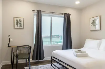 a bedroom with a bed and a desk and a window at Modern 2BR&2BAQueen BedWork DeskWiFiWD in Philadelphia