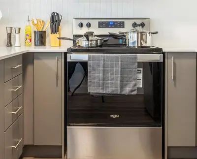 a kitchen with an oven with two pots and pans at 2-Bed&2-BathWDCentralKitchenWifiDesk in Philadelphia