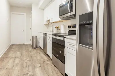 a kitchen with white cabinets and stainless steel appliances at 2-Bed&2-BathWDCentralKitchenWifiDesk in Philadelphia