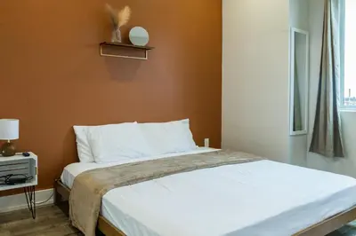 a bedroom with a large bed with white sheets at 3BR3Bath Home with King Beds Sleeps 8 in Philadelphia