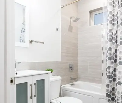 a bathroom with a toilet and a sink and a tub at 3BR3Bath Home with King Beds Sleeps 8 in Philadelphia