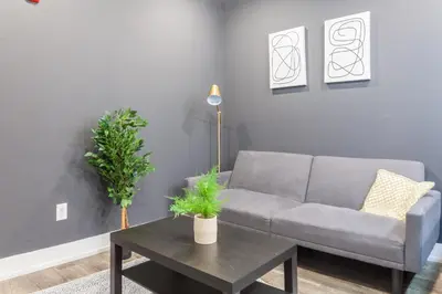 a living room with a couch and a table at Spacious 3-Bed3BathKing BedsTVWasherDryer in Philadelphia