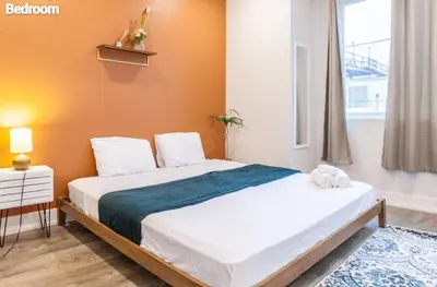 a bedroom with a bed and a window at Spacious 3-Bed3BathKing BedsTVWasherDryer in Philadelphia
