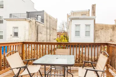 a patio with chairs and a table on a balcony at Spacious 3-Bed3BathKing BedsTVWasherDryer in Philadelphia