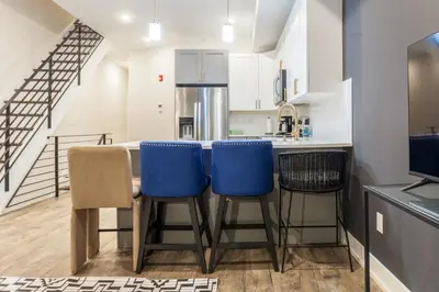 a kitchen with a table and blue chairs in a kitchen at City 3Bed3BAKing Beds,Washer & Dryer,Free Parking in Philadelphia