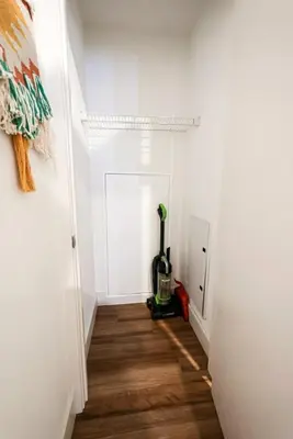 a hallway with a vacuum in a white room at 1bdrmapartment In The-heartofphiladelphia in Philadelphia