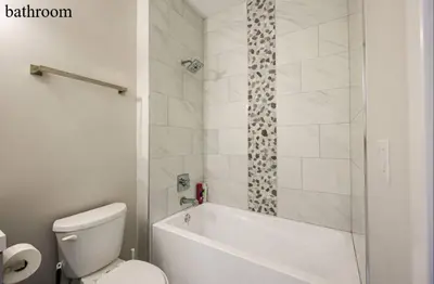 a bathroom with a tub and a toilet and a shower at Central 1BR1BAKing BedWiFiWD in Philadelphia