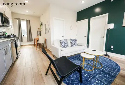 a living room with a couch and a table at Central 1BR1BAKing BedWiFiWD in Philadelphia