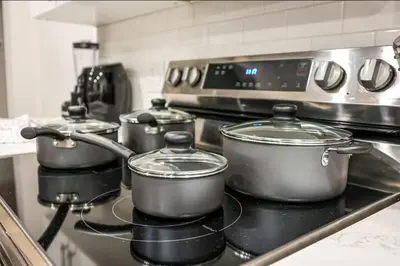 three pots sitting on top of a stove in a kitchen at Central 1BR1BAKing BedWiFiWD in Philadelphia