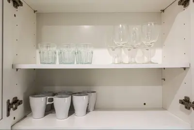 a row of wine glasses sitting on a shelf at Central 1BR1BAKing BedWiFiWD in Philadelphia