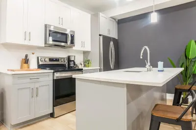 a kitchen with white cabinets and a sink and a microwave at 3Bed3BathWDDeskWiFiHeating in Philadelphia