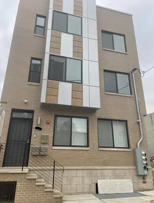 a tall brick building with a staircase in front of it at 3Bed3BathWDDeskWiFiHeating in Philadelphia