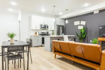 a kitchen and living room with a table and chairs at 3Bed3BathWDDeskWiFiHeating in Philadelphia