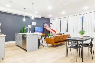 a kitchen and living room with a table and chairs at 3Bed3BathWDDeskWiFiHeating in Philadelphia