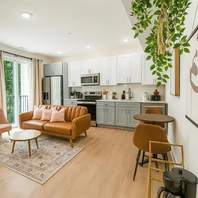 a living room with a couch and a kitchen at 1Bed1Bath-CentralKingBed,WD,WIFI in Philadelphia