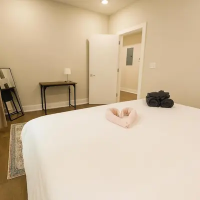 a bedroom with a white bed with a pink towel on it at 1Bed1Bath-CentralKingBed,WD,WIFI in Philadelphia